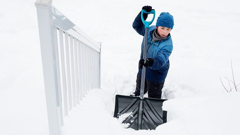a child shovelling snow