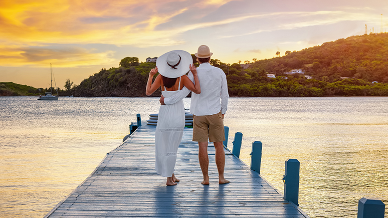 backview of a couple standing near water