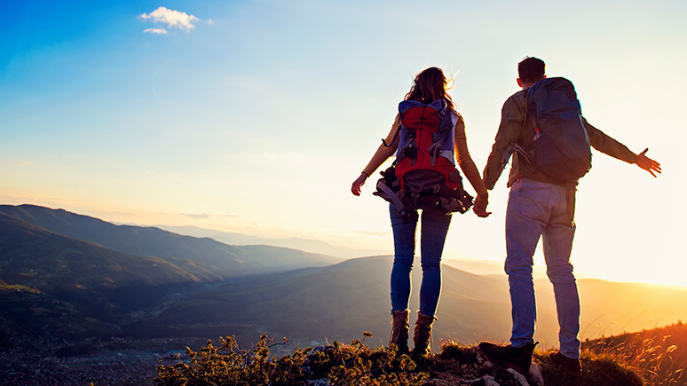 two hikers standing by a cliff
