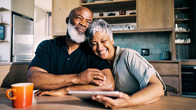 an older couple sitting in a kitchen