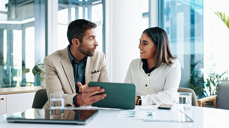 a woman and a man chatting in an office