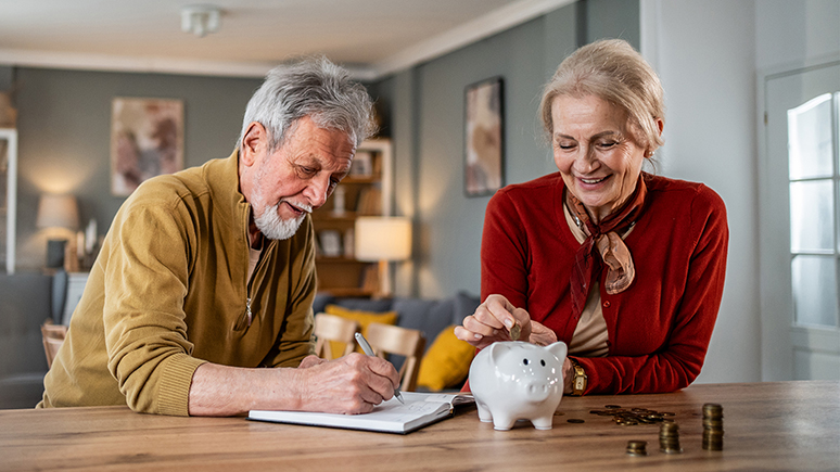 an older couple with a piggy bank on the table