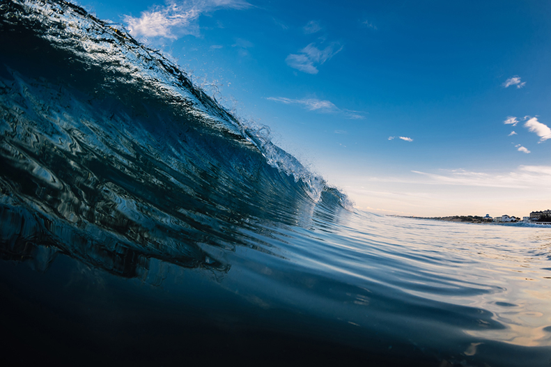 Blue barrel wave in ocean. Breaking sea wave