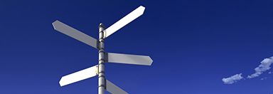Signpost with three blank signs on sky backgrounds