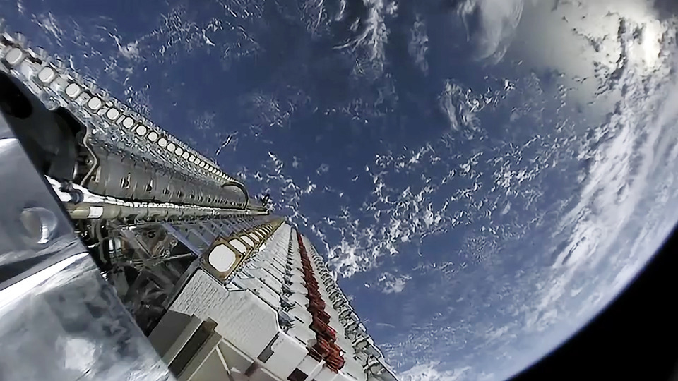 picture of space showing part of a rocket and part of planet Earth