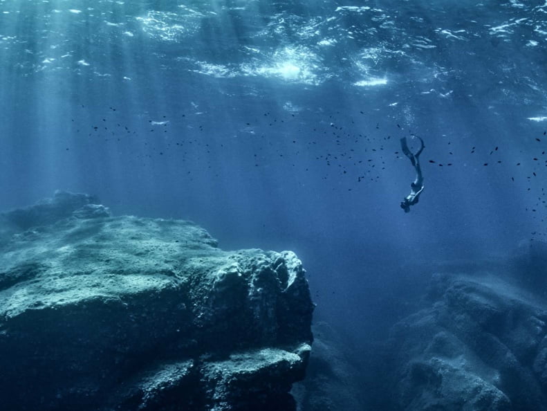 Decorative background image of a scuba diver