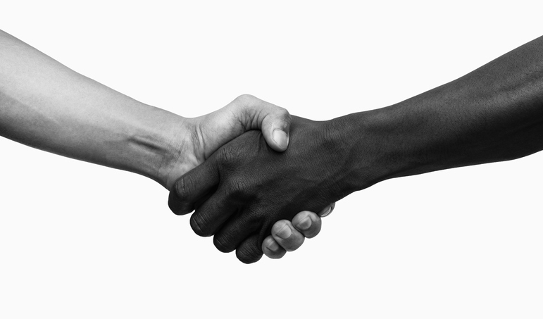 Africanâ  American and American shaking hands, Black and white image.